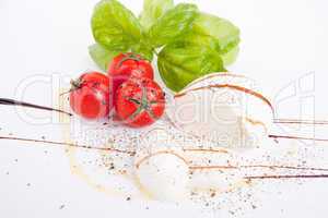 tasty tomatoe mozzarella salad with basil on white