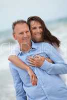 happy adult couple in summertime on beach