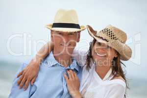 happy adult couple in summertime on beach