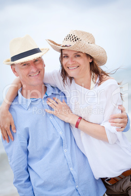 happy adult couple in summertime on beach