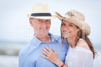 happy adult couple in summertime on beach