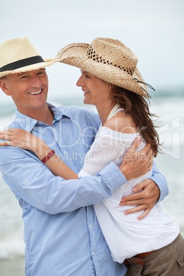 happy adult couple in summertime on beach