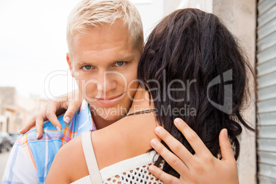 Romantic handsome man hugging his girlfriend