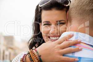 Beautiful radiant woman hugging her boyfriend