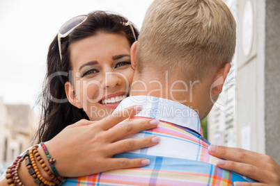 Beautiful radiant woman hugging her boyfriend