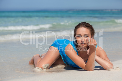 attractive young woman in blue dress on the beach