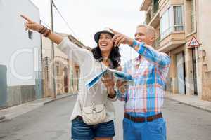 Young couple of tourists consulting a map