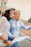 Young couple of tourists consulting a map