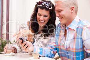 young smiling couple in cafe outdoor in summer