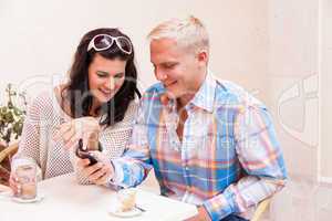 young smiling couple in cafe outdoor in summer