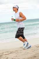 man is jogging on the beach summertime sport fitness