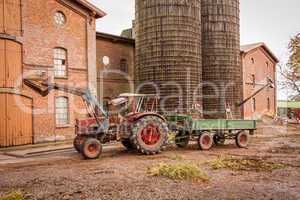 Tractor and trailer in a farmyard