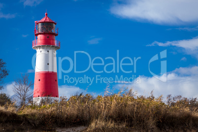 landscape baltic sea dunes lighthouse in red and white