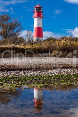 landscape baltic sea dunes lighthouse in red and white