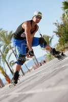 young man with inline skates in summer outdoor