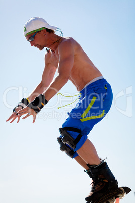 young man with inline skates in summer outdoor