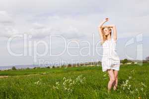 beautiful blonde woman outdoor in summer happy