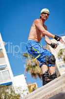young man with inline skates in summer outdoor