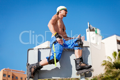 young man with inline skates in summer outdoor