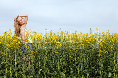 beautiful blonde girl in a field in summer