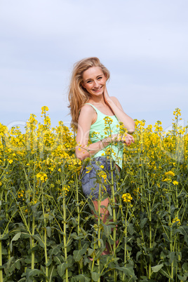 beautiful blonde girl in a field in summer