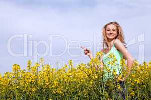 beautiful blonde girl in a field in summer