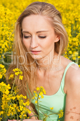 beautiful blonde girl in a field in summer