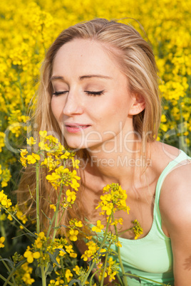 beautiful blonde girl in a field in summer