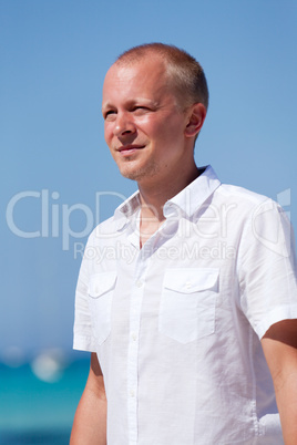 young man walking on the beach in holiday