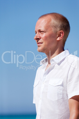 young man walking on the beach in holiday