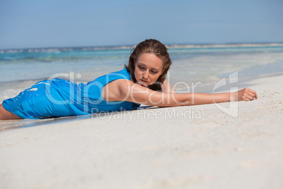 attractive young woman in blue dress on the beach