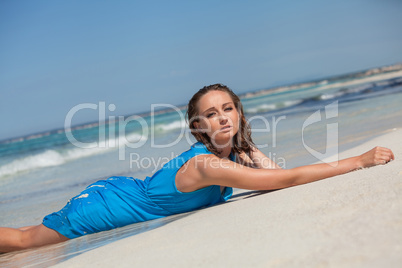 attractive young woman in blue dress on the beach