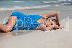 attractive young woman in blue dress on the beach