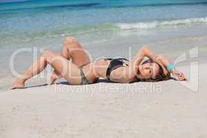 attractive woman in black bikini on the beach summertime