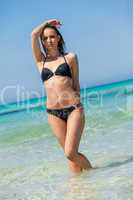 Female model wearing black bikini in the water