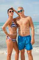 Sexy trendy couple posing in swimwear at the sea