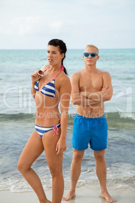 Sexy trendy couple posing in swimwear at the sea