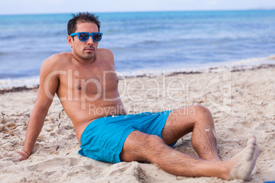 attractive young athletic man on the beach