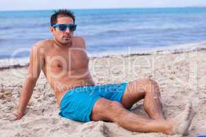 attractive young athletic man on the beach
