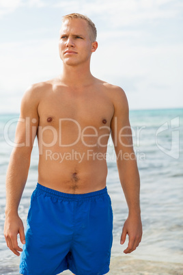 Man in blue swim shorts in the beach