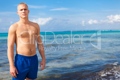 attractive young athletic man on the beach