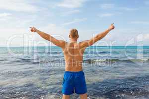 Man in blue swim shorts in the beach