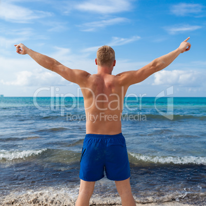 attractive young athletic man on the beach