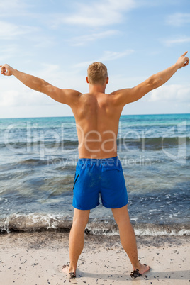 Man in blue swim shorts in the beach