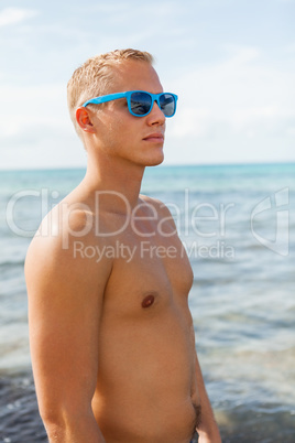 Man in blue swim shorts in the beach