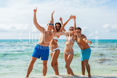 young happy friends havin fun on the beach