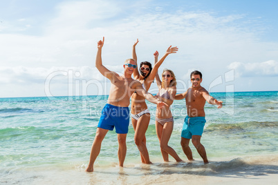 young happy friends havin fun on the beach