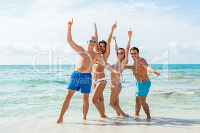 young happy friends havin fun on the beach