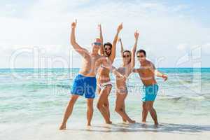 young happy friends havin fun on the beach