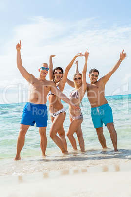 young happy friends havin fun on the beach